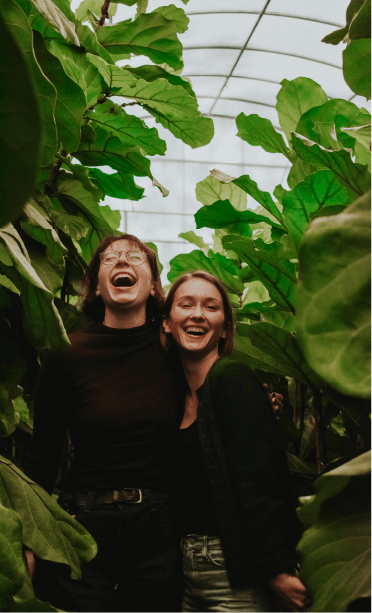 laughing Two women smiling and laughing inside a large garden