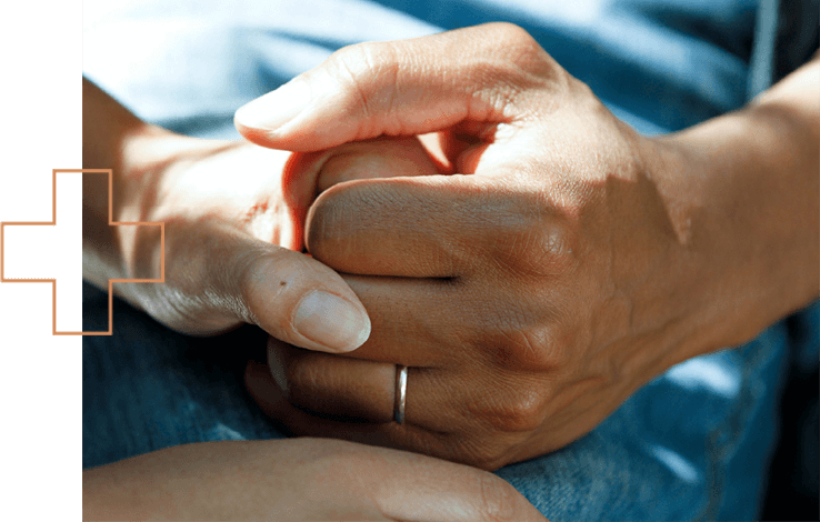 Two people hold hands