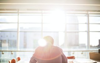 A man works at a sunlight filled table